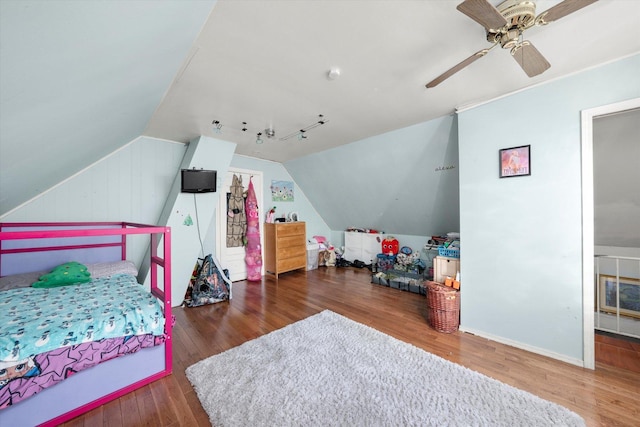 bedroom with ceiling fan, wood-type flooring, and vaulted ceiling