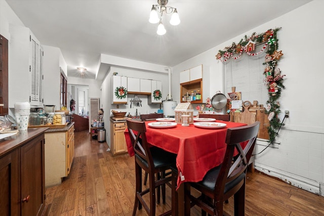 dining space with dark hardwood / wood-style flooring