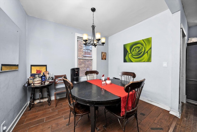 dining space featuring an inviting chandelier and dark wood-type flooring