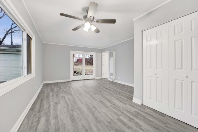 unfurnished living room featuring light hardwood / wood-style floors, ceiling fan, and crown molding