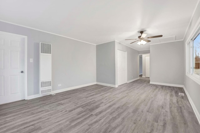 spare room with light hardwood / wood-style floors, ceiling fan, and ornamental molding