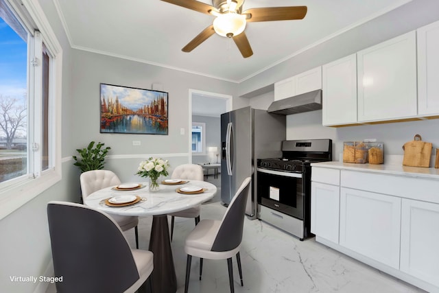 kitchen featuring ceiling fan, ornamental molding, appliances with stainless steel finishes, white cabinetry, and extractor fan