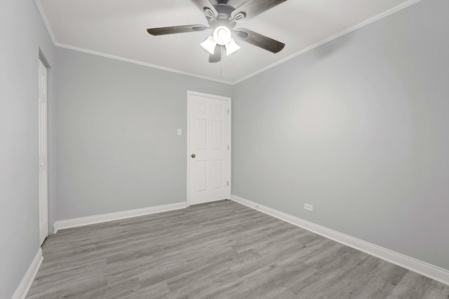 empty room with ceiling fan, crown molding, and light hardwood / wood-style flooring