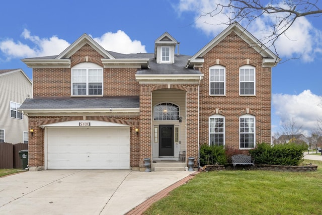 view of front of property with a garage and a front yard