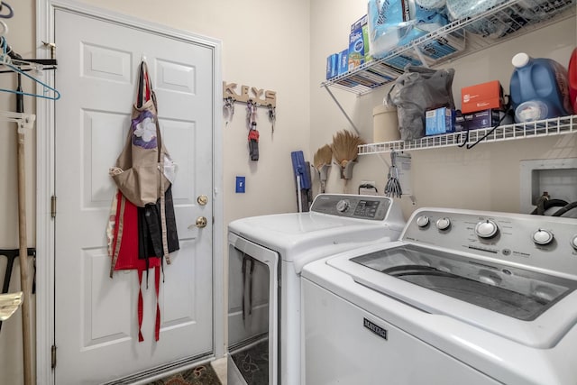 washroom featuring washer and clothes dryer