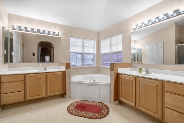 bathroom featuring tile patterned flooring, vanity, and lofted ceiling