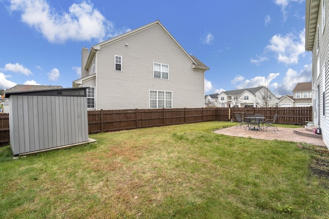 view of yard featuring a shed and a patio area