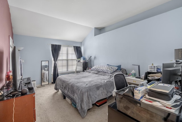 bedroom featuring light carpet and vaulted ceiling