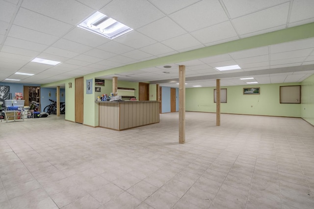 basement with a paneled ceiling