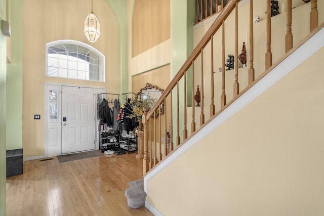 entrance foyer with light wood-type flooring and a high ceiling