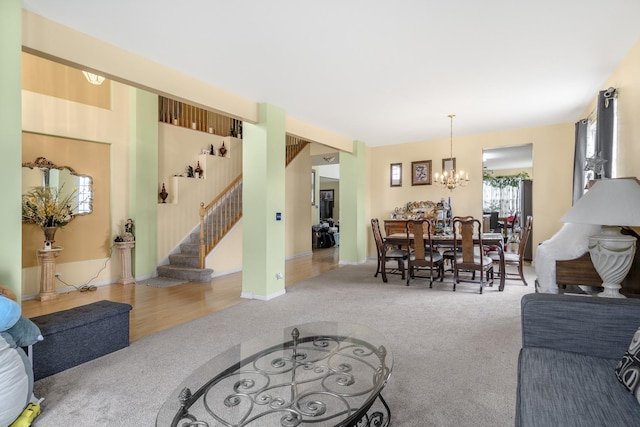 carpeted living room featuring a chandelier