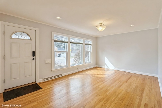 entrance foyer with light wood-type flooring and crown molding