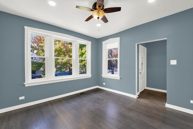 spare room with ceiling fan and dark wood-type flooring