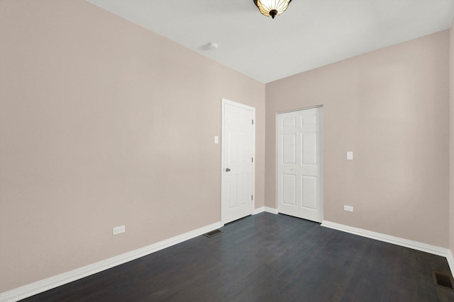 unfurnished room with dark hardwood / wood-style floors