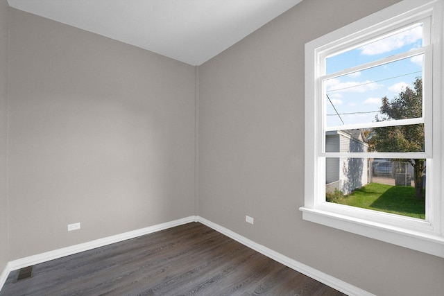 unfurnished room with dark hardwood / wood-style flooring