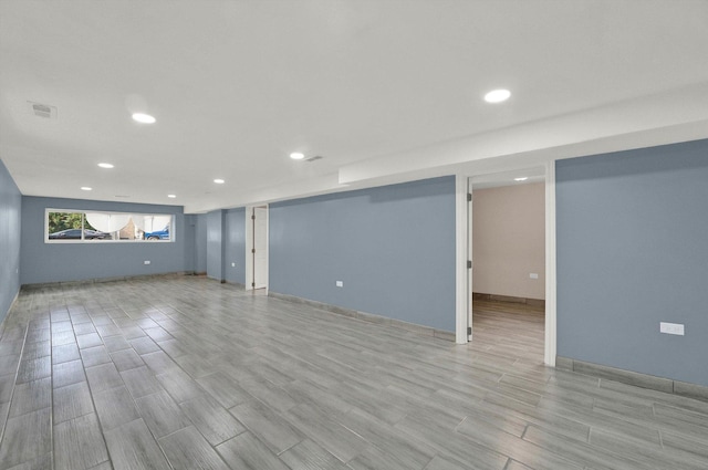 basement with light hardwood / wood-style flooring