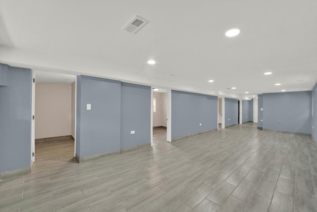 basement with light hardwood / wood-style flooring