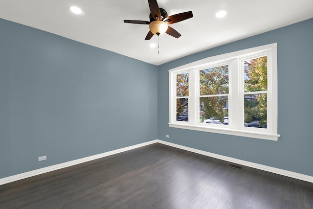 spare room featuring ceiling fan and dark hardwood / wood-style floors