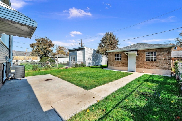 view of yard featuring central air condition unit and a patio