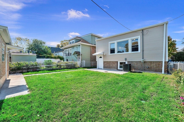 rear view of house featuring a lawn and cooling unit