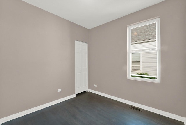 empty room with dark hardwood / wood-style floors