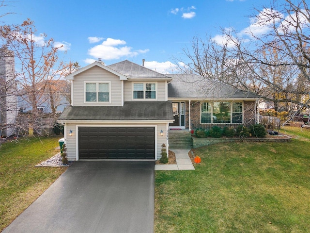 tri-level home featuring covered porch, a garage, and a front lawn