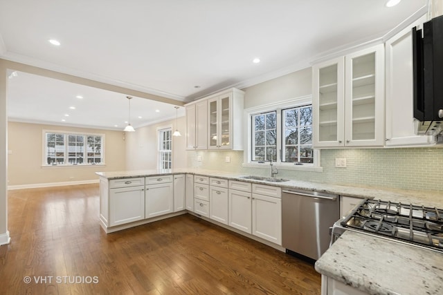 kitchen with stainless steel dishwasher, white cabinetry, sink, and pendant lighting