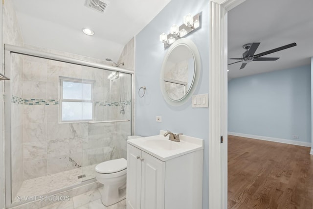 bathroom with toilet, a shower with door, vanity, and ceiling fan