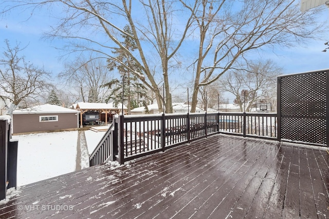 snow covered deck with an outdoor structure