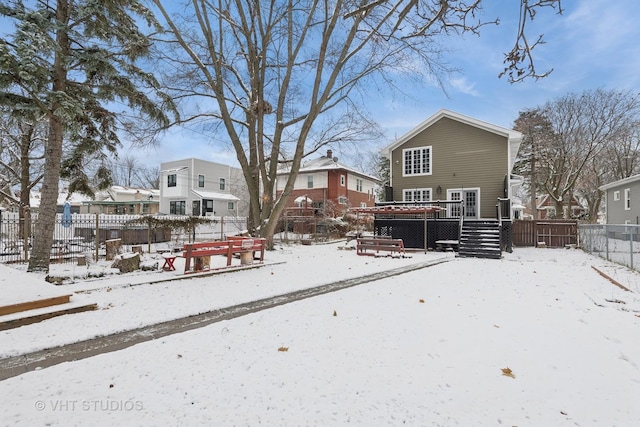 view of snow covered rear of property