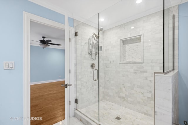 bathroom with ceiling fan, ornamental molding, hardwood / wood-style floors, and a shower with shower door