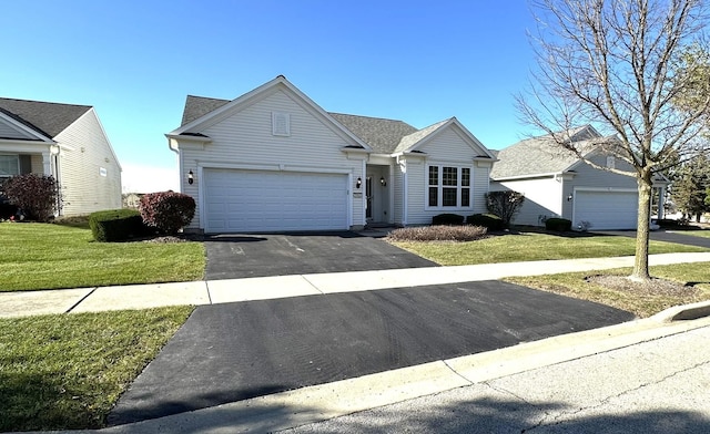 ranch-style house featuring a garage and a front lawn