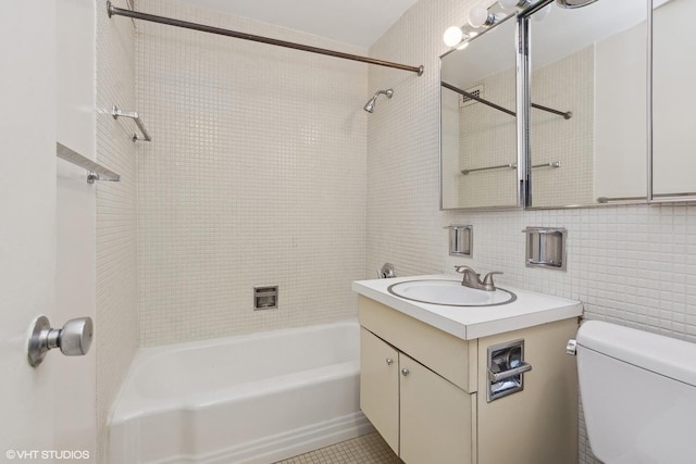 full bathroom with vanity, tile patterned flooring, decorative backsplash, toilet, and tile walls