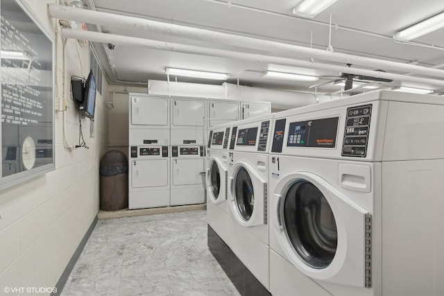 clothes washing area featuring washer and dryer and stacked washer / dryer