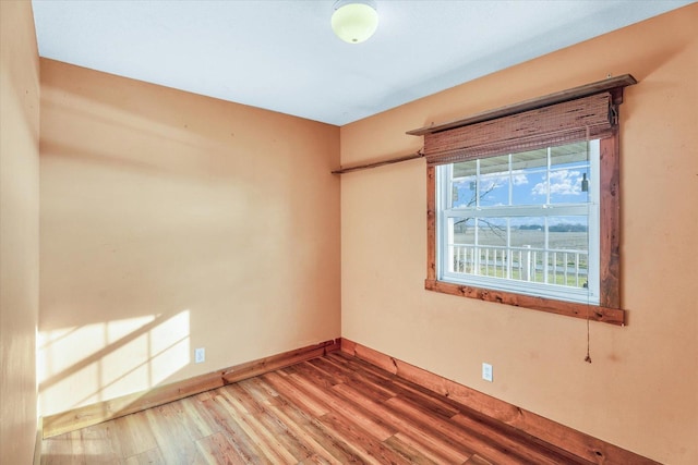 empty room with hardwood / wood-style flooring