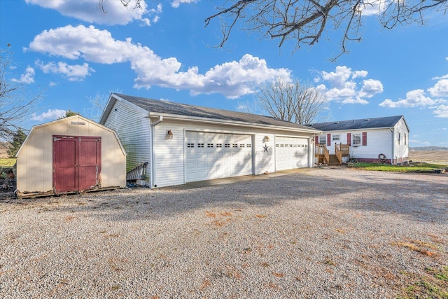 view of front of house with a shed and a garage