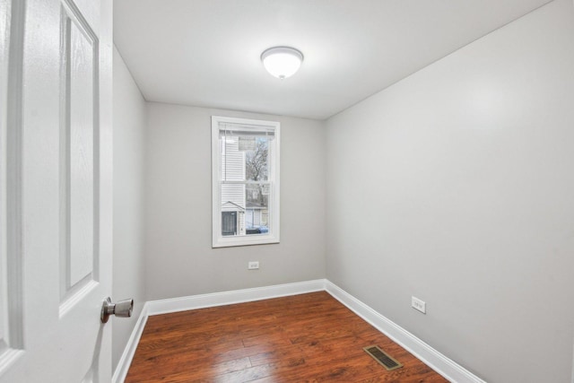 unfurnished room featuring dark hardwood / wood-style flooring