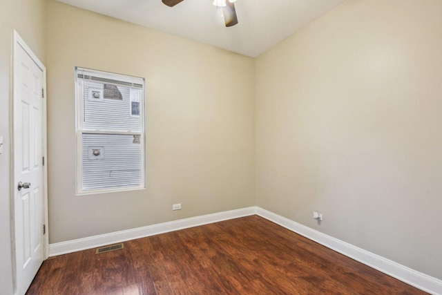 spare room featuring dark hardwood / wood-style flooring and ceiling fan