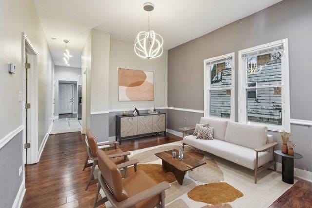 living room featuring hardwood / wood-style floors and a notable chandelier