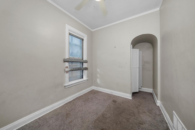 carpeted spare room featuring crown molding and ceiling fan