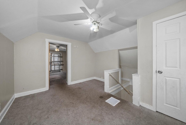 bonus room with ceiling fan, vaulted ceiling, and dark colored carpet