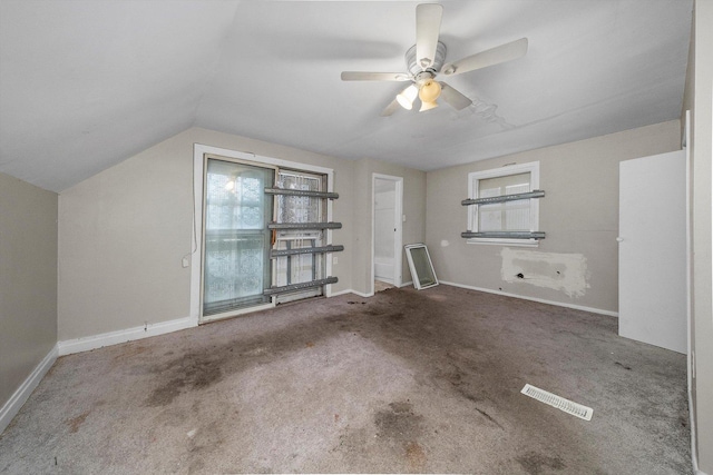 interior space featuring carpet flooring, ceiling fan, and vaulted ceiling