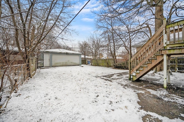 snowy yard featuring an outdoor structure