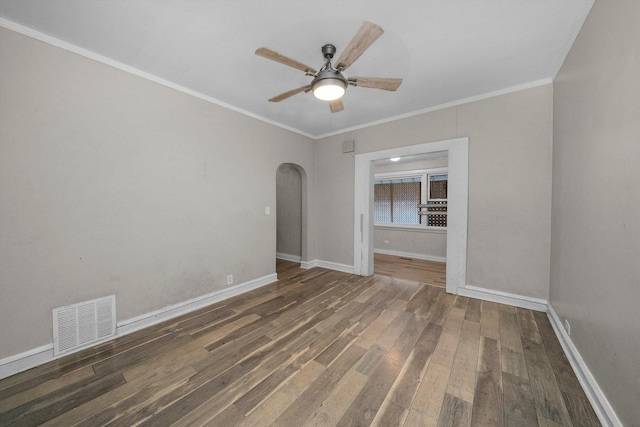 empty room featuring crown molding, dark hardwood / wood-style flooring, and ceiling fan