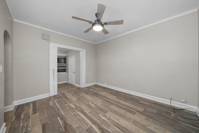 empty room featuring dark hardwood / wood-style floors, ceiling fan, and crown molding