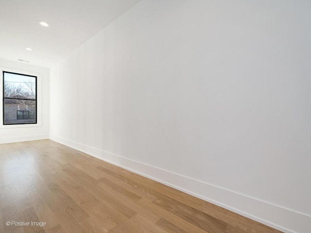 empty room with light hardwood / wood-style flooring