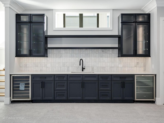 kitchen featuring light colored carpet, wine cooler, and sink