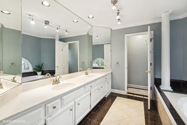 full bathroom featuring ornamental molding, a garden tub, a sink, and decorative columns