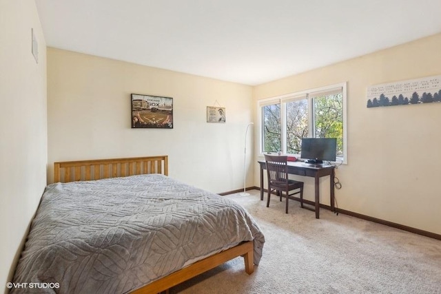 bedroom featuring carpet and baseboards