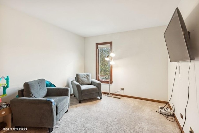 living area with carpet floors, visible vents, and baseboards